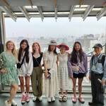 Tourists from the US and China enjoy shopping in the rain