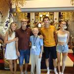 A family of four from Italy enjoys a conversation with a Buddhist monk.